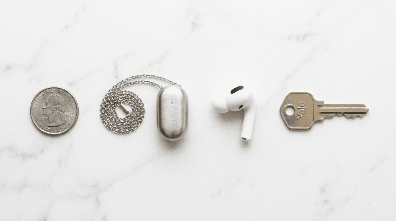 Size comparison — pendant next to quarter, AirPod, and key